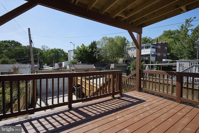 wooden terrace featuring a storage unit