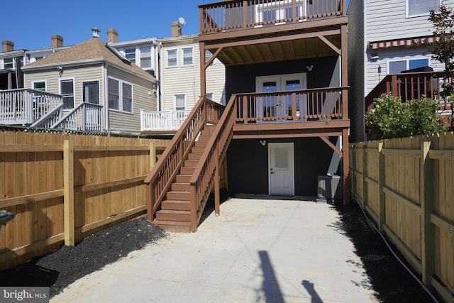 back of property featuring a patio and a deck