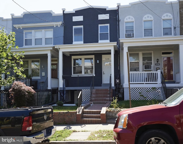 townhome / multi-family property featuring a porch