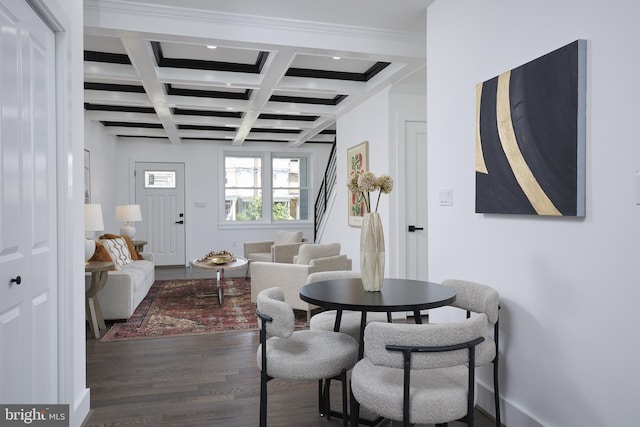 dining space with coffered ceiling, beamed ceiling, and dark hardwood / wood-style floors