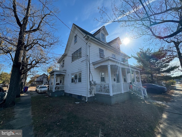 view of side of property featuring a porch