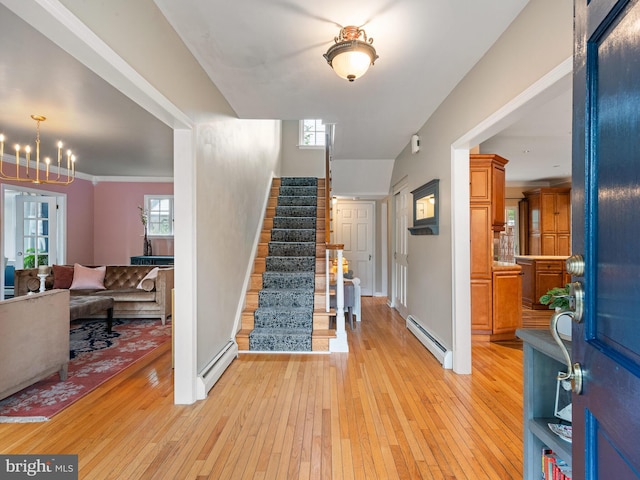 entryway featuring light hardwood / wood-style flooring, a wealth of natural light, and a baseboard radiator