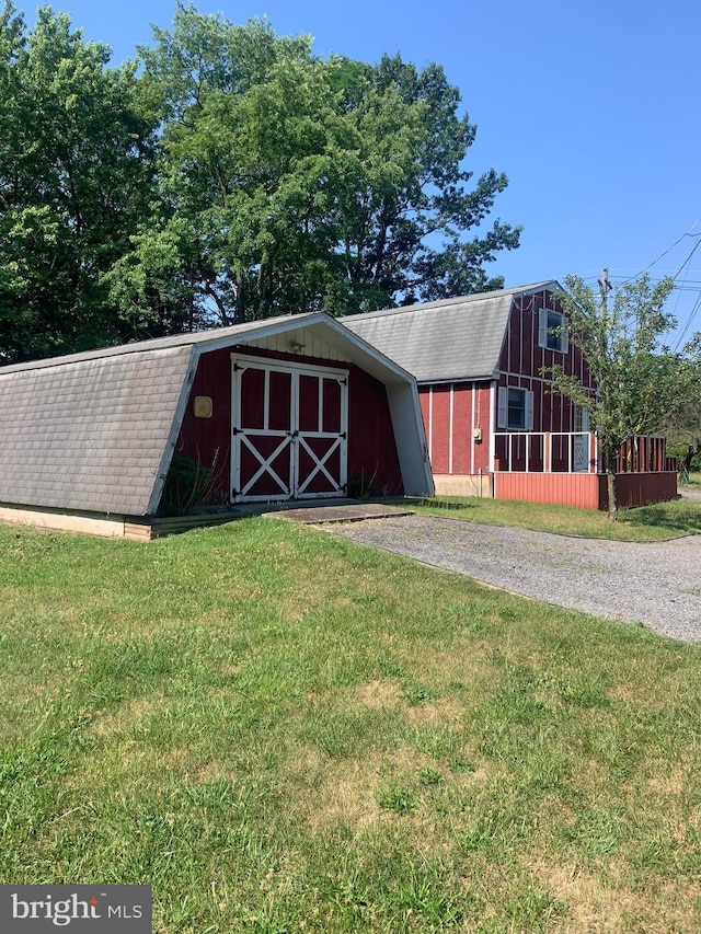 view of outdoor structure with a lawn