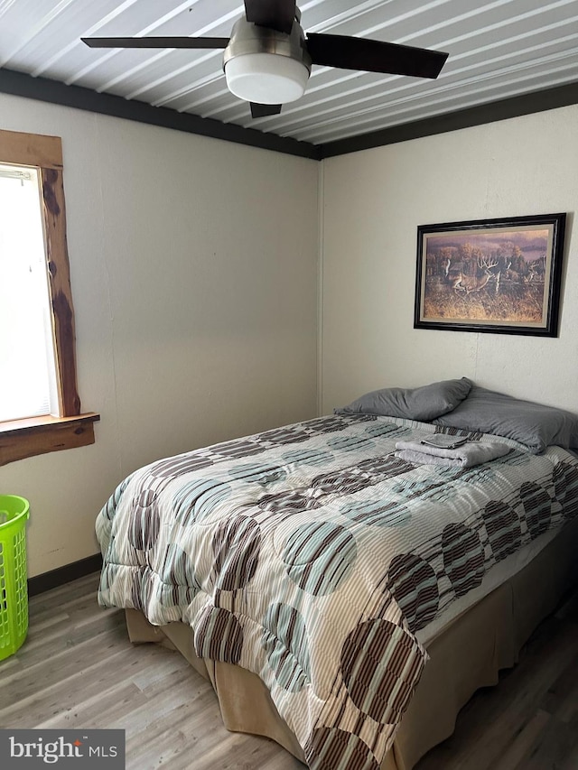 bedroom featuring light wood-type flooring and ceiling fan