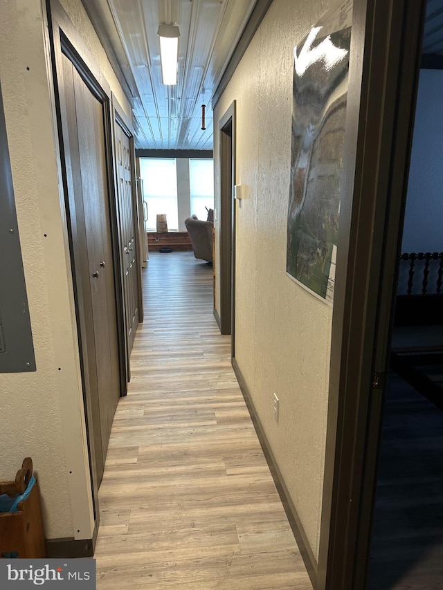 corridor with light hardwood / wood-style floors