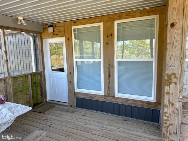 view of exterior entry featuring a wooden deck