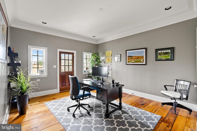 home office featuring light wood-type flooring and ornamental molding