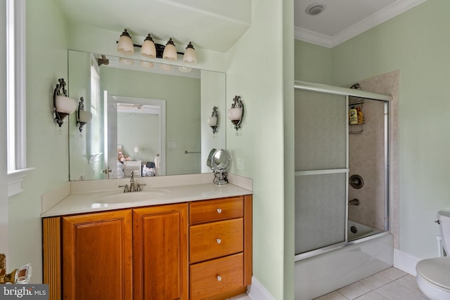 full bathroom with shower / bath combination with glass door, vanity, tile patterned floors, crown molding, and toilet