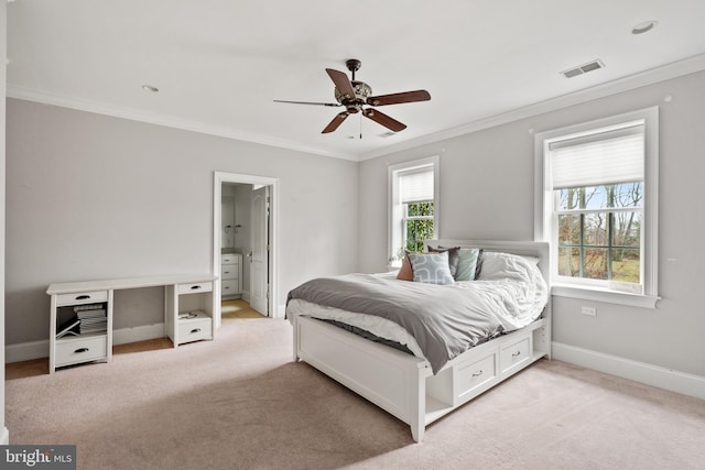 carpeted bedroom with ceiling fan, crown molding, and ensuite bathroom