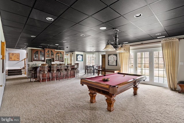 recreation room featuring carpet flooring, a drop ceiling, french doors, pool table, and bar area