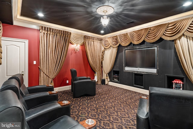 carpeted cinema room featuring ornamental molding