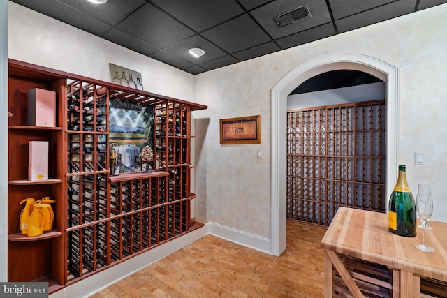 wine area featuring a drop ceiling