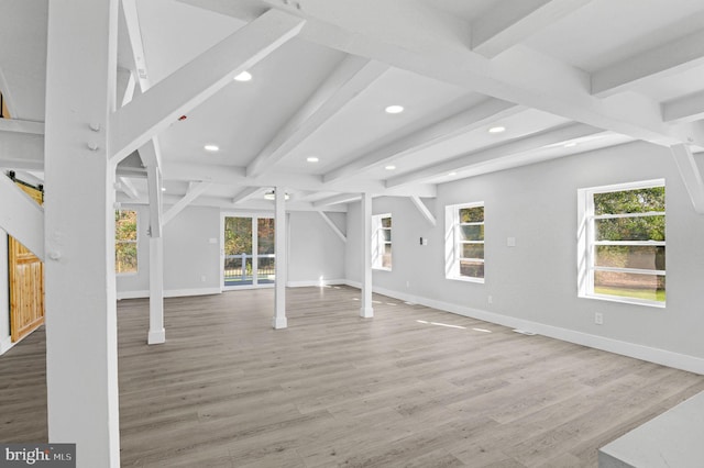 unfurnished living room with hardwood / wood-style flooring and beam ceiling