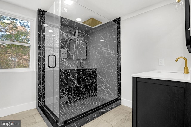 bathroom with an enclosed shower, vanity, and plenty of natural light