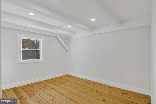 additional living space featuring hardwood / wood-style floors and beamed ceiling