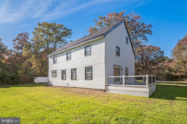 back of house with a yard and a deck