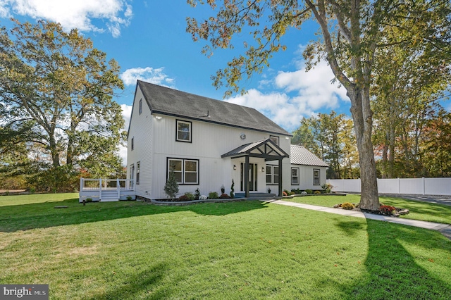 view of front of home featuring a wooden deck and a front yard