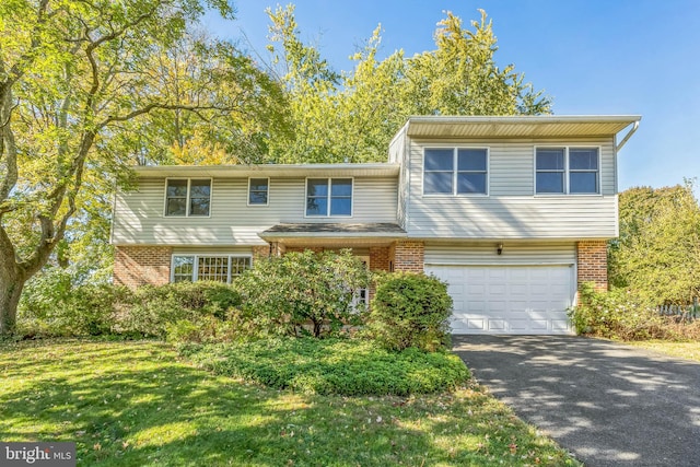 view of front of property with a front lawn and a garage