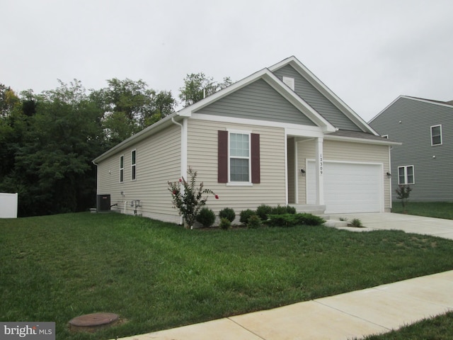 view of front of home featuring central AC unit, a garage, and a front lawn