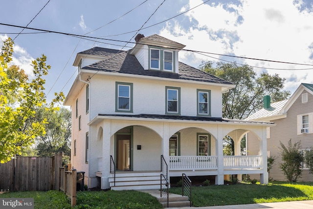 view of front facade with covered porch and a front yard