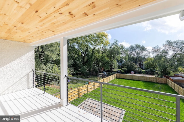 wooden deck with a lawn