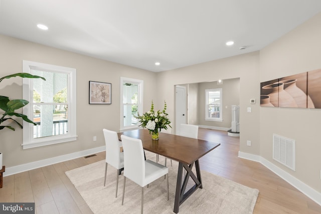 dining area with light wood-type flooring and a healthy amount of sunlight