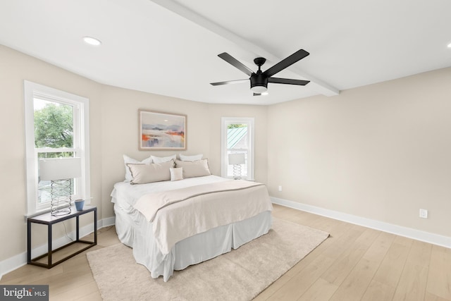 bedroom featuring multiple windows, ceiling fan, and light hardwood / wood-style floors