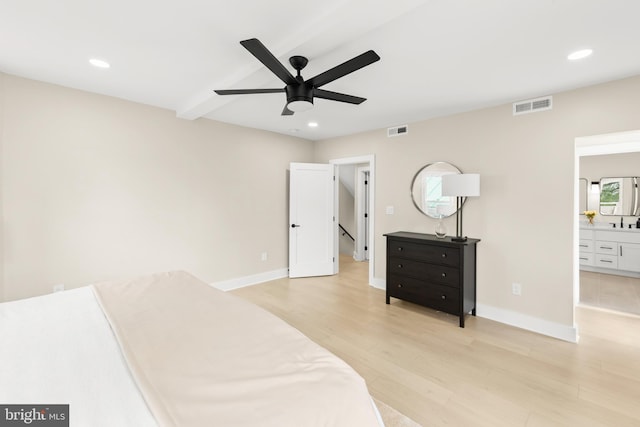 bedroom with beamed ceiling, ceiling fan, sink, light hardwood / wood-style flooring, and ensuite bathroom