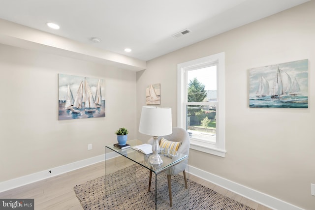 home office with light hardwood / wood-style floors