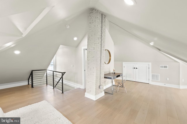 bonus room featuring lofted ceiling and light wood-type flooring