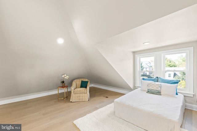 bedroom featuring vaulted ceiling and hardwood / wood-style floors