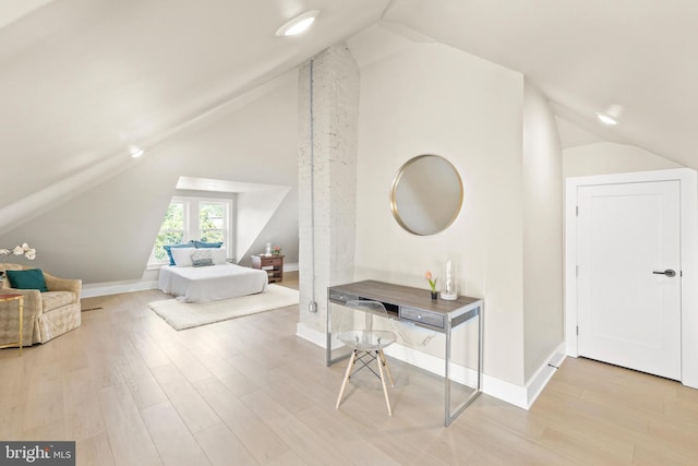 bedroom featuring lofted ceiling and light hardwood / wood-style floors