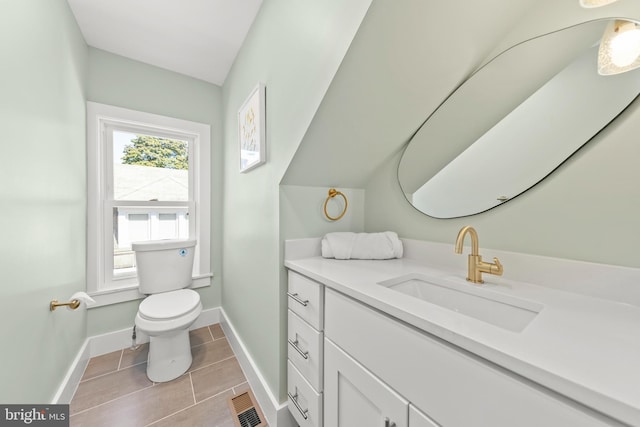 bathroom featuring tile patterned floors, vanity, and toilet