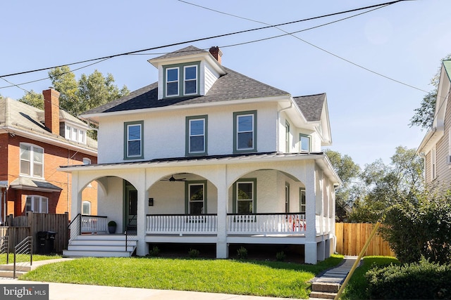 view of front facade featuring a front lawn and covered porch