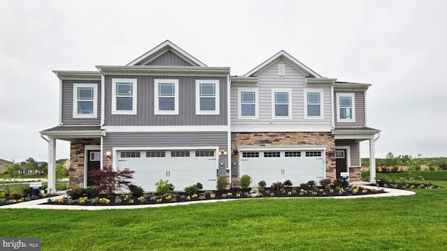 view of front of home with a front yard and a garage