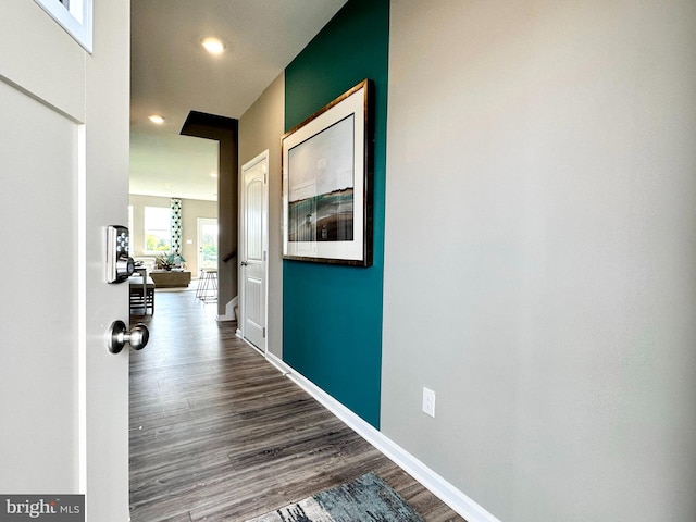 hallway with hardwood / wood-style floors