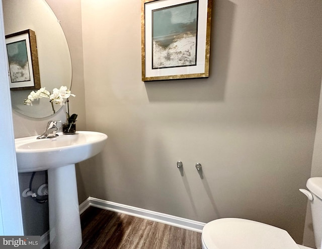 bathroom featuring hardwood / wood-style floors and toilet