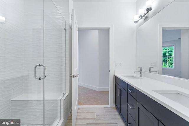 bathroom with walk in shower and vanity