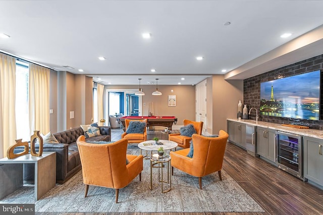 living room featuring wet bar, beverage cooler, dark wood-type flooring, and pool table