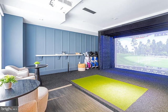 game room with dark carpet and golf simulator