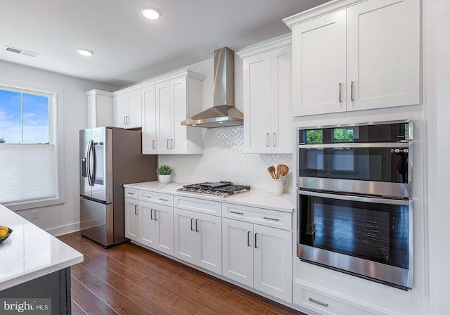 78 Old Mill Bottom Rd N Unit 112, Annapolis, MD 21409 - kitchen featuring dark wood finished floors, backsplash, light countertops, wall chimney range hood, and appliances with stainless steel finishes