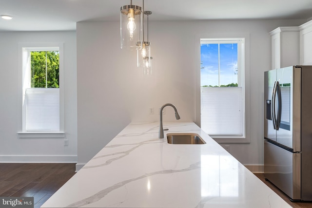 78 Old Mill Bottom Rd N Unit 112, Annapolis, MD 21409 - kitchen featuring light stone counters, a sink, pendant lighting, stainless steel fridge, and dark wood-style flooring