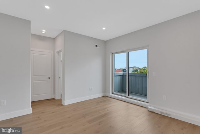 empty room with light hardwood / wood-style floors