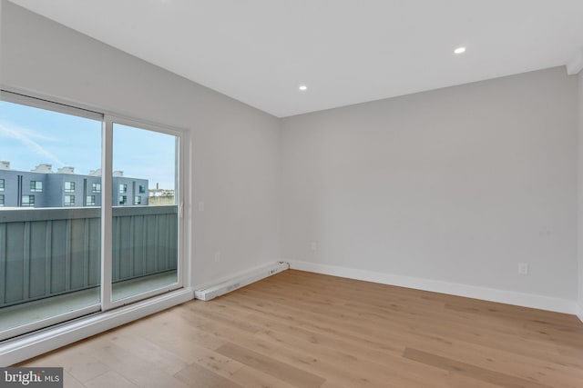 spare room featuring light hardwood / wood-style flooring