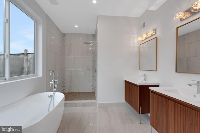 bathroom with vanity and separate shower and tub