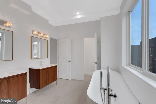 bathroom featuring a bathing tub and vanity