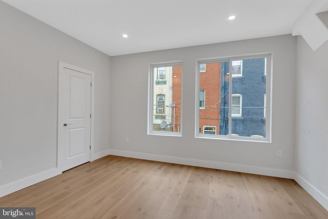 spare room with light hardwood / wood-style flooring