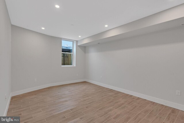 basement with light hardwood / wood-style floors