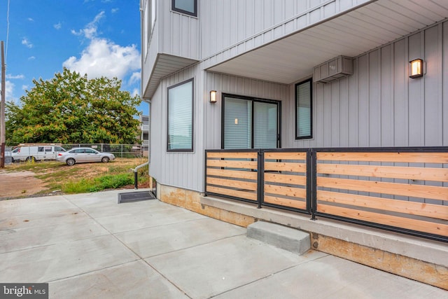 view of exterior entry with a patio area