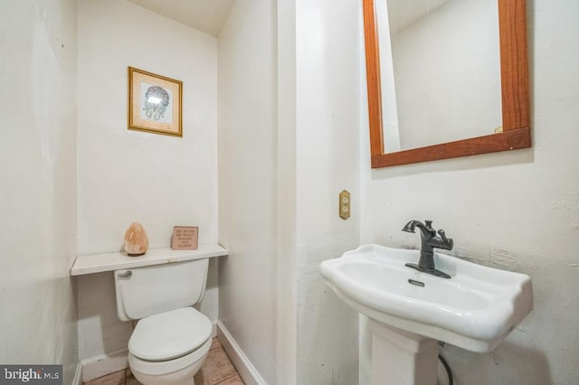 bathroom featuring sink, toilet, and tile patterned floors